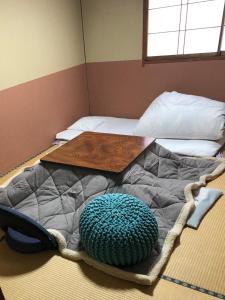 长野梅岡日式旅馆的一张床上有桌子的床
