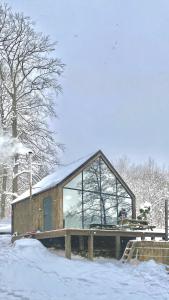 普日维兹Szklana Stodoła的一座小建筑,在雪中设有大窗户