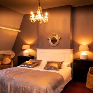 霍林赫姆霍林赫姆城市公寓的一间卧室配有一张床和一个吊灯