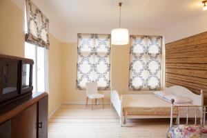 派尔努Aia Guest Apartment的一间卧室配有床和两个带窗帘的窗户