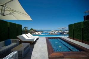 朱尼耶Veer Luxury Boutique Hotel & Beach Club的一个带躺椅和遮阳伞的游泳池