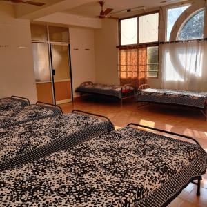 乌杜皮Bedspace Living的带两张床和两个窗户的房间