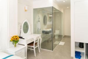 头顿Sun Hill Hotel的白色的浴室设有水槽和镜子