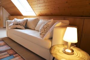 里肯巴赫Gästehaus Willaringen的一个带枕头的沙发,放在带灯的房间