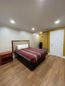 圣布鲁诺Ritz Inn-San Francisco Airport SFO的一间卧室配有一张床,铺有木地板