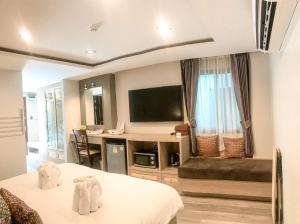 清迈Hotel De Sripoom -SHA Extra Plus的酒店客房设有两张床和一台平面电视。