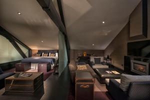 贝尔法斯特马尔马逊贝尔法斯特酒店的客房设有两张床、一张沙发和一个壁炉。