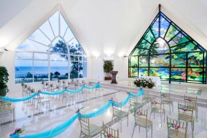 长滩岛安可纳度假酒店的客房设有桌椅和彩色玻璃窗。