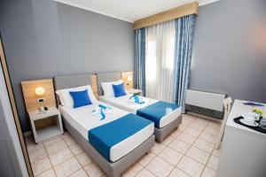 圣托斯特凡诺港Bike&Boat Argentario Hotel的酒店客房设有两张床和窗户。