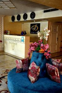 甘贾Deluxe Hotel Ganja的一间设有蓝色长沙发的鲜花客房