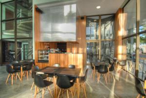 纳塔尔Ilusion Flat -Natal的餐厅设有桌椅和窗户。
