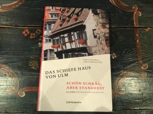 乌尔姆Hotel Schiefes Haus的一本书,上面有房子的照片