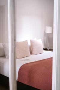 陶朗加利邦码头陶朗加酒店的一间卧室配有带白色床单和枕头的床。