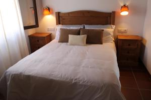 UserasCasa Rural Mas dels Fumeros的卧室配有一张带两个枕头的大白色床