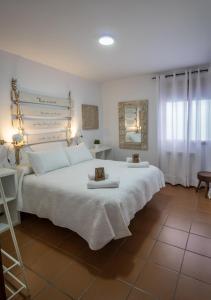 卡索拉Alojamientos Siente Cazorla的卧室配有一张白色大床和两条毛巾