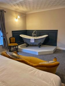 科宁斯比莱格特酒店的带浴缸和椅子的浴室