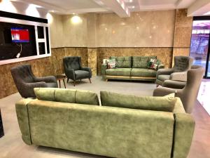 MahmutluGrand Atakum Boutıque Hotel的客厅配有绿色沙发和椅子