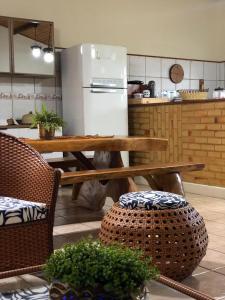 巴拉多库努casa em Barra de Cunhaú-RN的厨房配有桌子和冰箱