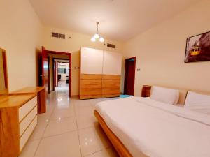 迪拜Private rooms in 3 bedroom apartment SKYNEST Homes marina pinnacle的卧室配有白色大床和梳妆台