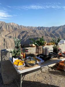拉斯阿尔卡麦قرية الحمرا راس الخيمة的山顶上带食物的野餐桌
