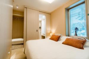 沃索Mere 38 Apartments的卧室设有一张白色大床和一扇窗户。