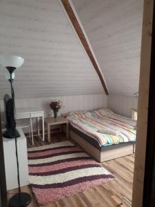 KrynkiFAZENDA - Przytulne pokoje na krańcu świata的一间卧室配有一张床和地毯