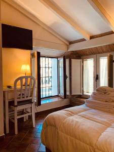扎弗拉格兰德广场酒店的卧室配有一张床、一张书桌和窗户。