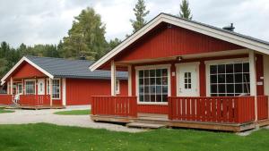 伯Beverøya Hytteutleie og Camping的红色的房子,有白色的门和窗户
