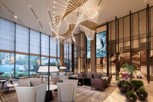 广州佛山南海利泰皇冠假日酒店-广州南站的大堂设有桌椅和大型玻璃墙