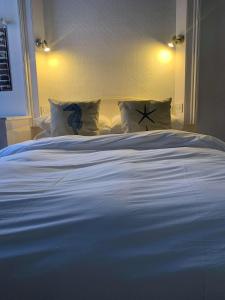 克劳奇河畔伯纳姆Ye Olde White Harte Hotel的卧室内的一张带枕头的大型白色床