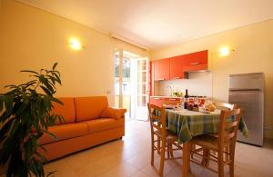 波蒙特Appartamenti - Villa Mare的厨房以及带桌子和沙发的客厅。