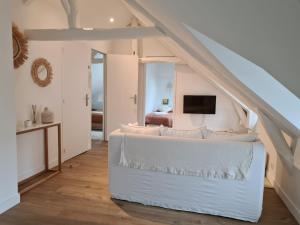 瓦讷Santorin, Appartement lumineux au coeur de Vannes的卧室配有白色的床和电视