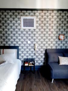 比亚里茨Saint Charles Hôtel & Coliving Biarritz的一间卧室配有一张床和一张蓝色椅子