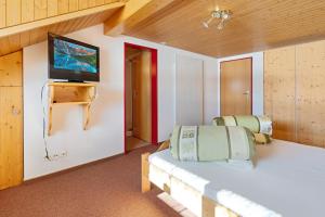 GontenSwiss Mountain Golf-Restaurant Gonten的客房设有两张床和一台平面电视。