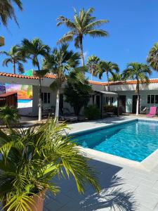 棕榈滩阿鲁巴酒店的棕榈树屋前的游泳池
