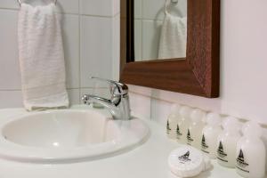 圣地亚哥San Ignacio Suite的浴室设有水槽、镜子和奶瓶