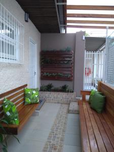 布卢梅瑙Pousada Bonatti的庭院设有木凳和墙上的植物