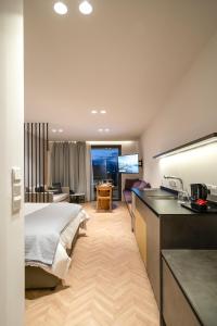 利马索尔Alinea Suites Limassol Center的酒店客房带一张床和一个厨房