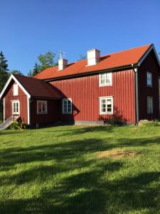 AnebyFråsttorp的绿色田野上红色屋顶的谷仓