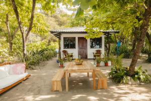 圣塔特蕾莎海滩Villas Paraiso Azul的小房子,配有桌子和沙发