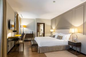 彼蒂高伊恩伊利亚特约热吉亚酒店的卧室配有一张白色大床和一张书桌