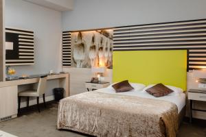 杜布罗夫尼克莱拉酒店的酒店客房配有一张床、一张书桌和一张书桌。