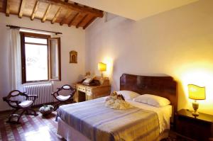 巴尔贝里诺瓦尔德尔萨Il Torrino的一间卧室配有一张床、一张书桌和一个窗户。