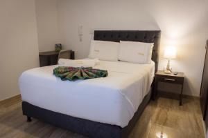 皮塔利托Samalá Casa Hotel的卧室配有一张带白色床单和枕头的大床。