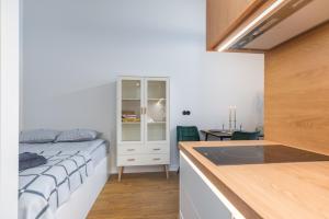 塔尔图Cosy Duo Loft - free GYM的一间卧室配有一张床,厨房配有柜台