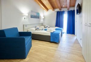 丰迪Il Beccaria Relais B&B的一间卧室配有一张床和两张蓝色椅子