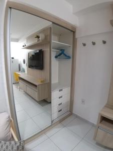 特雷西纳Smart Residence Flat - FLAT 605的客房设有镜子、书桌和电视。