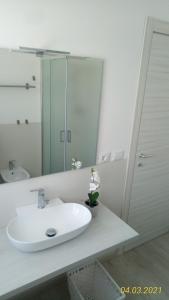 卡托利卡B&B IL NIDO的白色的浴室设有水槽和镜子