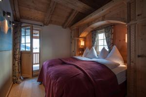 克拉瓦德尔伯格霍夫萨丁度假屋的一间带一张大床的卧室,位于一个拥有木制天花板的房间