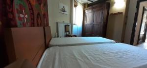 GaressioAntico Convento的一间卧室设有两张床和木门